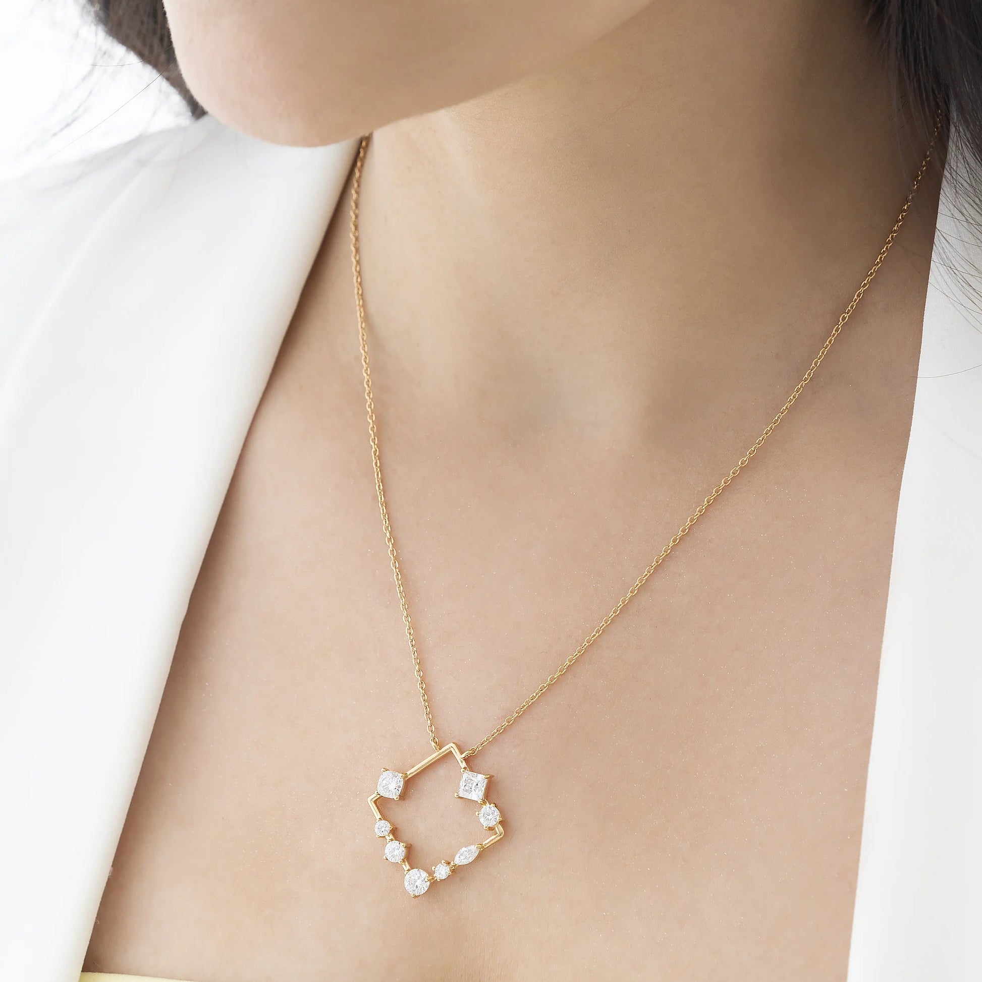 Detailed view of Idhani Elara Abstract Cluster Moissanite 925 Silver Necklace in 18K Gold Vermeil worn on a model
